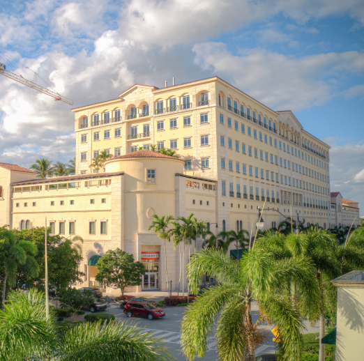 4000 Ponce office space, retail space, and exterior Spanish Mediterranean architecture surrounded by palm trees.
